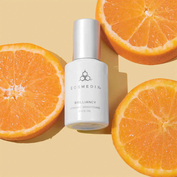 Brilliancy vitamin C brightening face oil bottle with slices of oranges
